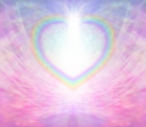 Rainbow Heart shape making a border on a radiating delicate pink background with a light burst at the top of the heart